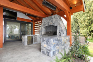 Luxury Outdoor Stone Kitchen with Red Cedar