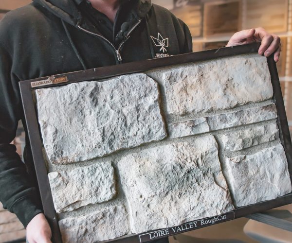 Greg holding up a stone veneer sample board