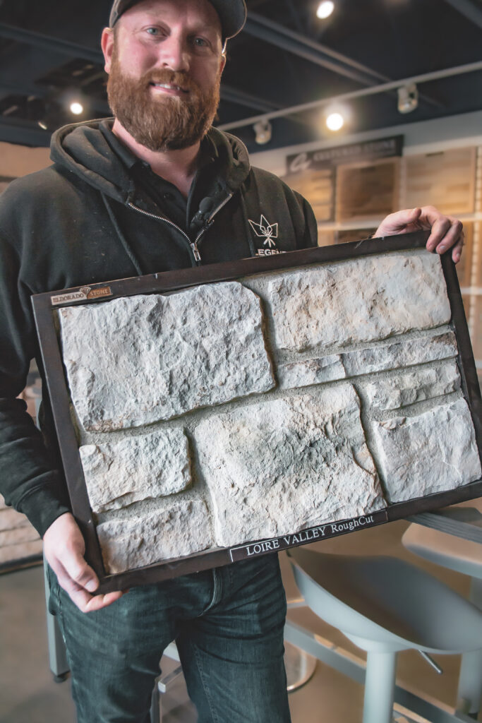 Greg holding up a stone veneer sample board
